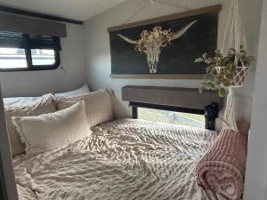 a bedroom with a bed with a deer head on the wall at Astoria in Round Top +10 photos