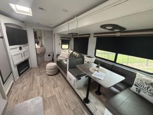 a rv living room with a couch and a table at Astoria in Round Top