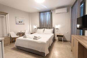 a hotel room with a bed and a television at ANAX APARTMENTS PARGA in Parga