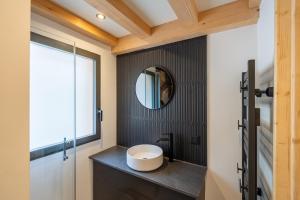 a bathroom with a sink and a mirror at Chalet Cocooning avec SPA Les Granges de Thuy in Thônes +14 photos