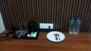 a table with a plate and two bottles of water at Murugammal residency in Tiruppatūr
