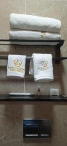 three towels on a shelf with towels on them at Murugammal residency in Tiruppatūr +38 photos
