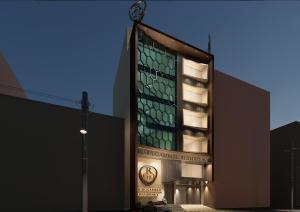 a building with a clock on the side of it at Murugammal residency in Tiruppatūr