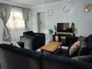 a living room with a couch and a tv at 399 Place in Umtali