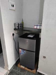 a small kitchen with a counter and a small refrigerator at 399 Place in Umtali +5 photos