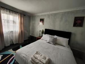 a bedroom with a large white bed with pillows at 399 Place in Umtali
