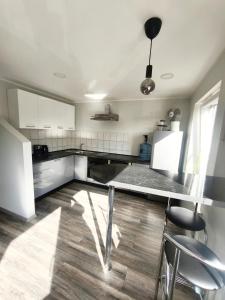 a kitchen with a table and some chairs in it at Friendly Apartment in Valmiera