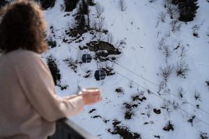 a woman flying a kite in the snow at Wohlfühlhotel Hubertushof am Arlberg - Ski-In & Ski-Out - Sky Pool in Stuben am Arlberg