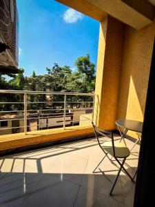 a balcony with a table and a chair on a balcony at Snow View Residences in Msaranga
