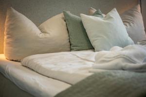 a white couch with pillows on top of it at Ostsee Suite 4 - Strandperle in Niendorf