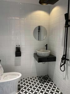 a white bathroom with a sink and a mirror at Nhật Quang House 2 in Danang +49 photos