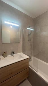 a bathroom with a sink and a shower and a tub at Maison prairie en fleurs in Le Perray-en-Yvelines