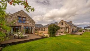 a house with a patio and a yard at The Hideaway in Banchory