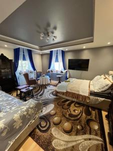 a bedroom with two beds and a living room at Warmiński Apartament in Biskupiec +1 photo
