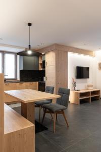 a kitchen with a large wooden table and chairs at Appartamento Rododendro in Andalo