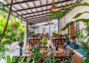 a patio with tables and chairs and plants at Angkor Eden Boutique Hotel in Siem Reap