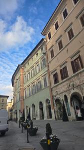 a group of buildings on a street with a van at Fontana Maggiore View Suite in Perugia