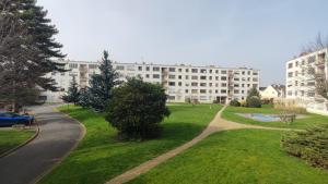 a park with a building in the background at Charming Bagneux Nest in Bagneux