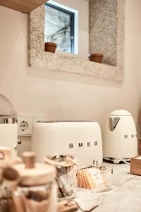 a white toaster sitting on a counter in a kitchen at Casa Juanita in Melide +49 photos
