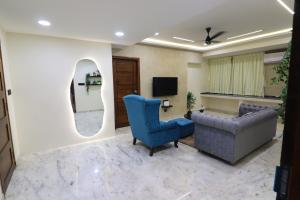 a living room with a couch and a tv at Luxury Villa in Falnir in Mangalore