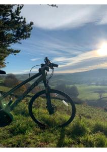 a bike parked on top of a grass covered hill at Alston House Hotel in Alston