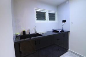 a kitchen with a sink and a window at Luxury Villa in Falnir in Mangalore
