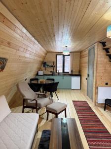a living room with a couch and a table at Take A Brake Kazbegi Cottage in Kazbegi