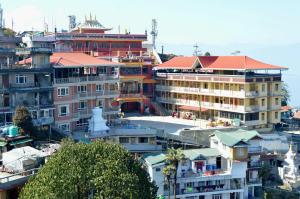 a group of buildings on top of a city at Tenzin's Inn in Jālāpahār
