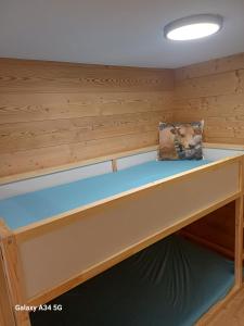 a bench in a sauna with a pillow on it at Le cocon de Mâche in Hérémence