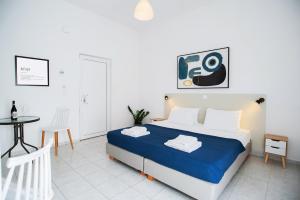 a bedroom with a bed and a table in it at Fardini Resorts in Kavos +6 photos