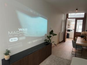 an office with a large projection screen on the wall at Holiday house with private jaccuzi - Leuven city center in Leuven