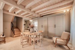 a dining room with a table and chairs and a staircase at Casa Juanita in Melide