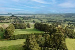 an aerial view of a green field with trees at Exclusive luxury tiny home in an idyllic setting in Glenquarry