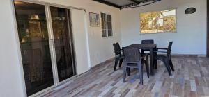 a dining room with a black table and chairs at Habitación en villa Costa del sol in Los Blancos