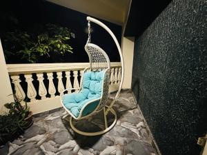 a swinging chair sitting on a balcony at Velouria Homestay in Guwahati