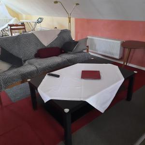 a living room with a couch with a table at Farbenfrohe Dachgeschoßwohnung in Giesen