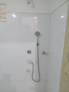 a shower with a shower head in a bathroom at Galoya Mahagedara in Inginiyagala