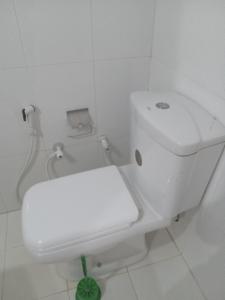 a bathroom with a white toilet in a white room at Galoya Mahagedara in Inginiyagala