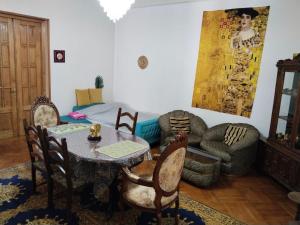 a living room with a table and chairs and a couch at Tilda&Matilda in Kutaisi