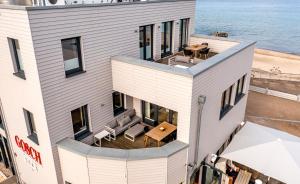 an aerial view of a building with a table and chairs at Ostsee Suite 5 - Strandperle in Niendorf +11 photos