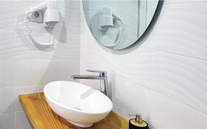 a bathroom with a white sink and a mirror at Casa João de Quintal in Elvas +2 photos