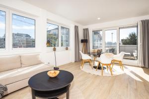 a living room with a couch and a table at Ostsee Suite 5 - Strandperle in Niendorf