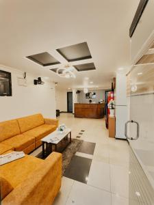 a living room with a couch and a table at HOTEL IHAM PARADISE - Near Mangalore Central Railway Station - Pets Not Allowed in Mangalore