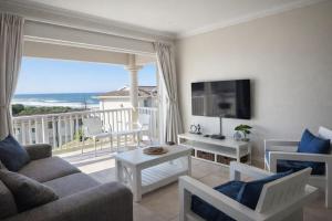 a living room with a view of the ocean at Hello Holiday at 4 Boboyi Mangrove Beach Estate in Port Shepstone