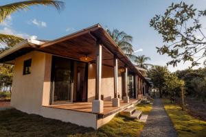 a resort building with a porch and a pathway at Manta Project in Morrillo