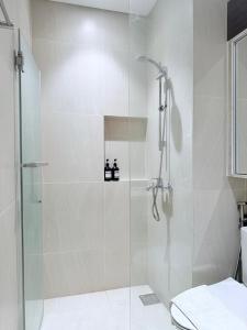 a shower with a glass door in a bathroom at Tambuli Ocean View Luxe Studios, Mactan Seaside Residences in Lapu Lapu City +36 photos
