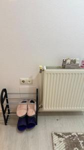 a pair of shoes sitting next to a radiator at Molly Nest in Gjakove