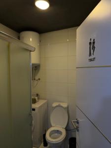 a small bathroom with a toilet and a sink at Molly Nest in Gjakove