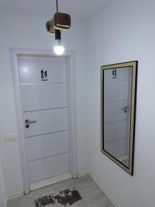 a mirror next to a door in a room at Molly Nest in Gjakove +23 photos