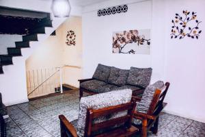 a living room with a couch and two chairs at Hostal B&C in Angra dos Reis